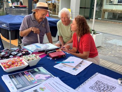 Community members visiting a pop-up information stall